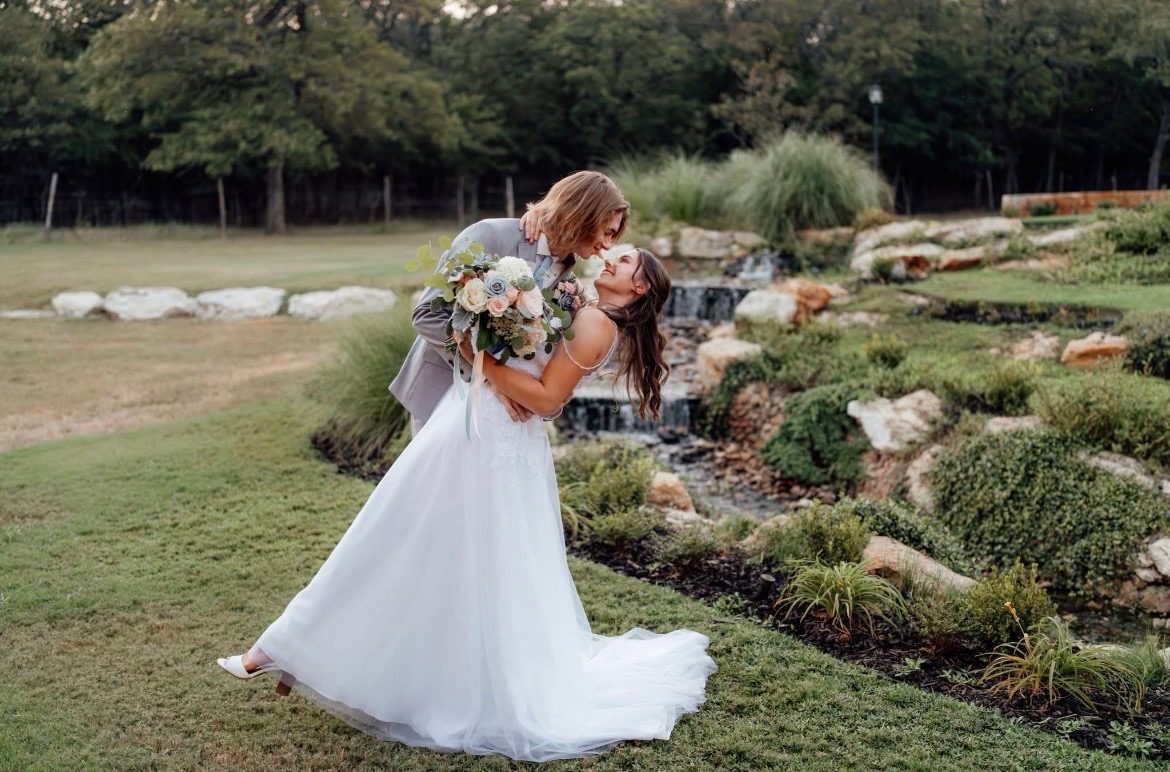Glory Unveiled by Bailey Elaine: couple embracing in a garden