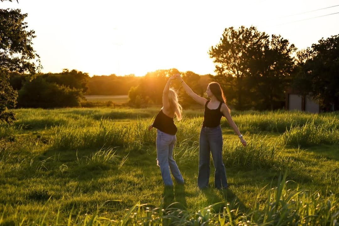 Lilylynne Photography: two friends dancing at golden hour in a field